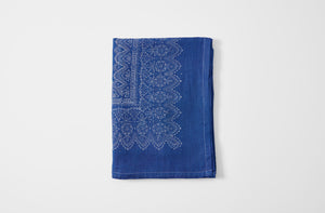 Hand printed bandana border indigo linen tablecloth folded.