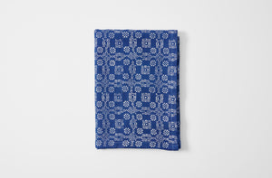 Hand printed checkered floral indigo linen tablecloth folded.