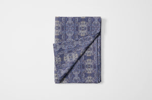 Hand-printed Venice indigo linen tablecloth folded with detail of reverse.