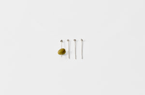 Heath Wagoner sterling silver knotted cocktail picks with olive.