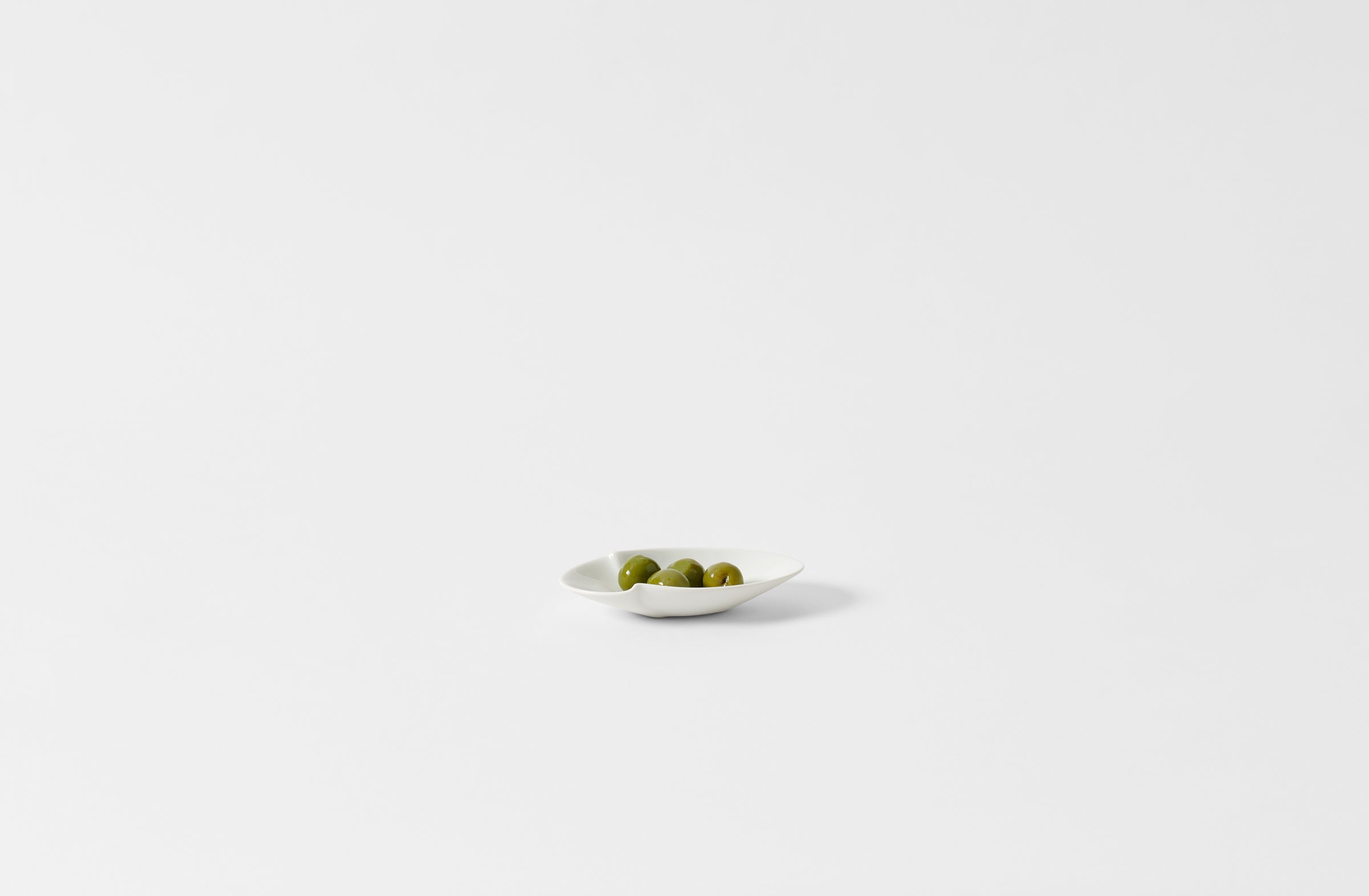 Hering Berlin petite white evolution oval dish holding olives.