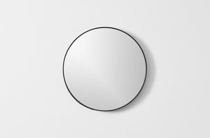 Ifuji black round mirror on wall.