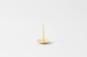 Ilse Crawford brass candle holder with candle