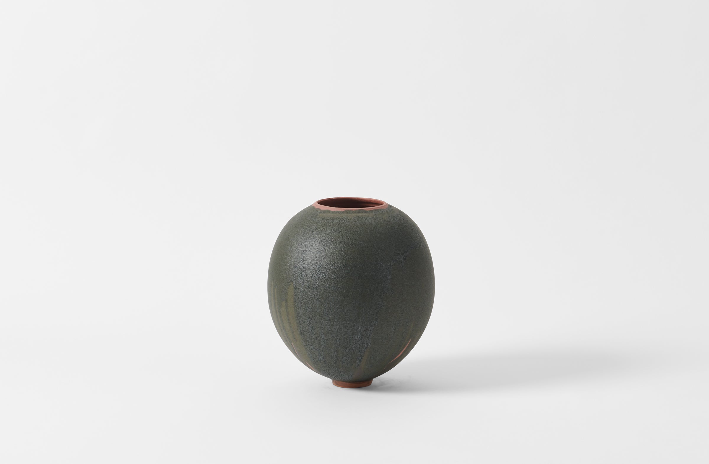 Karen Swami black glaze on red stoneware round vase.