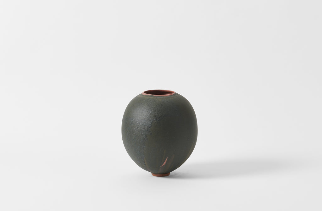 Karen Swami black glaze on red stoneware round vase.