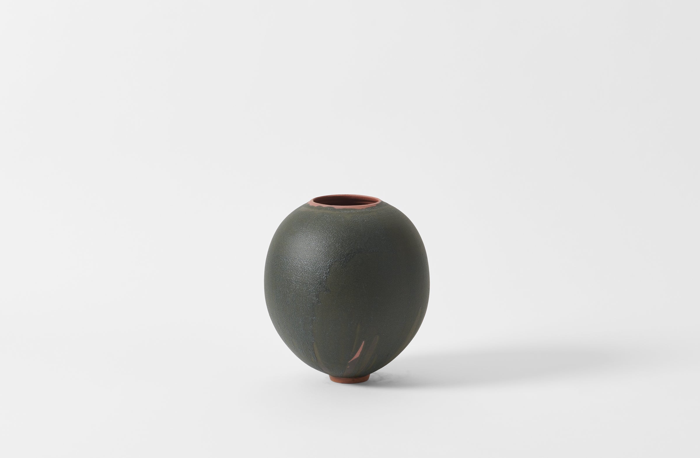 Karen Swami black glaze on red stoneware round vase.