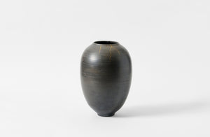 Karen Swami black smoke fired vessel with gold kintsugi.