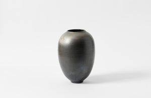 Karen Swami black smoke fired vessel with gold kintsugi.