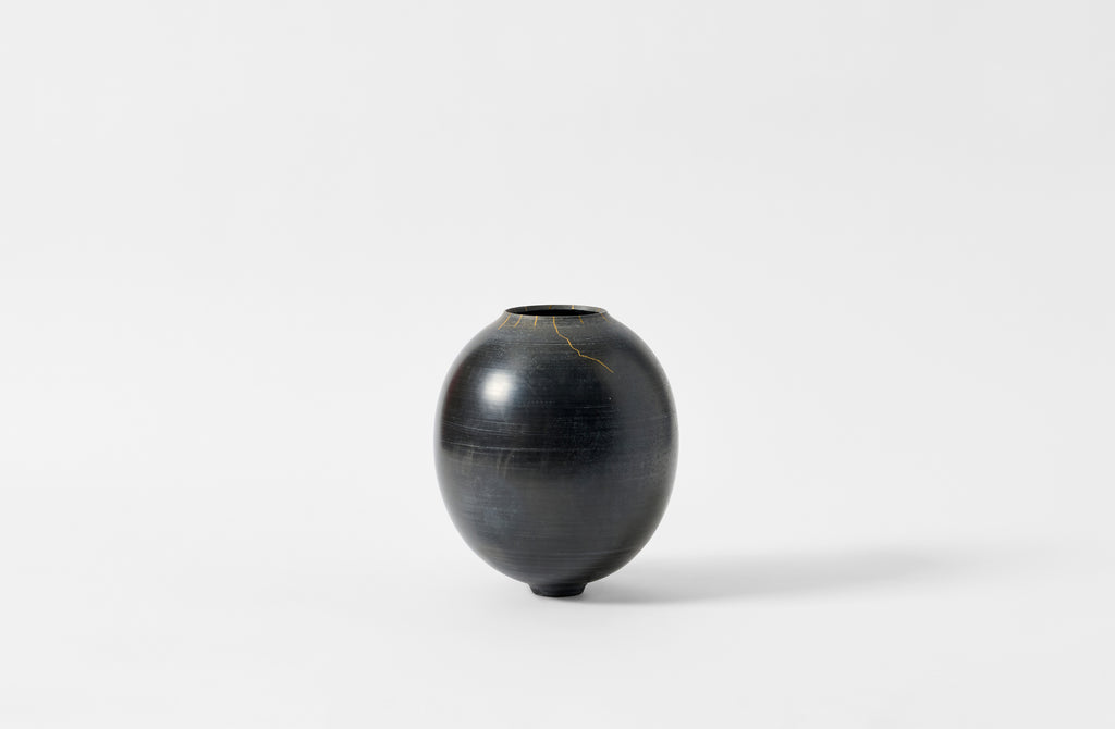 Karen Swami smoke fired vessel with gold kintsugi.