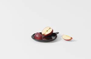 La Mére Ebony plate with handle holding sliced apple