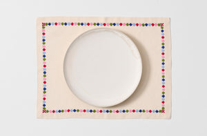 Licia embroidered placemat with plate.