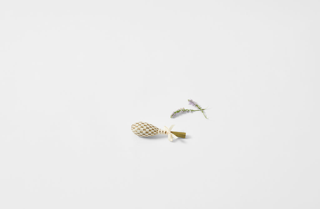 Petite lavender wand in linen next to sprig of lavender