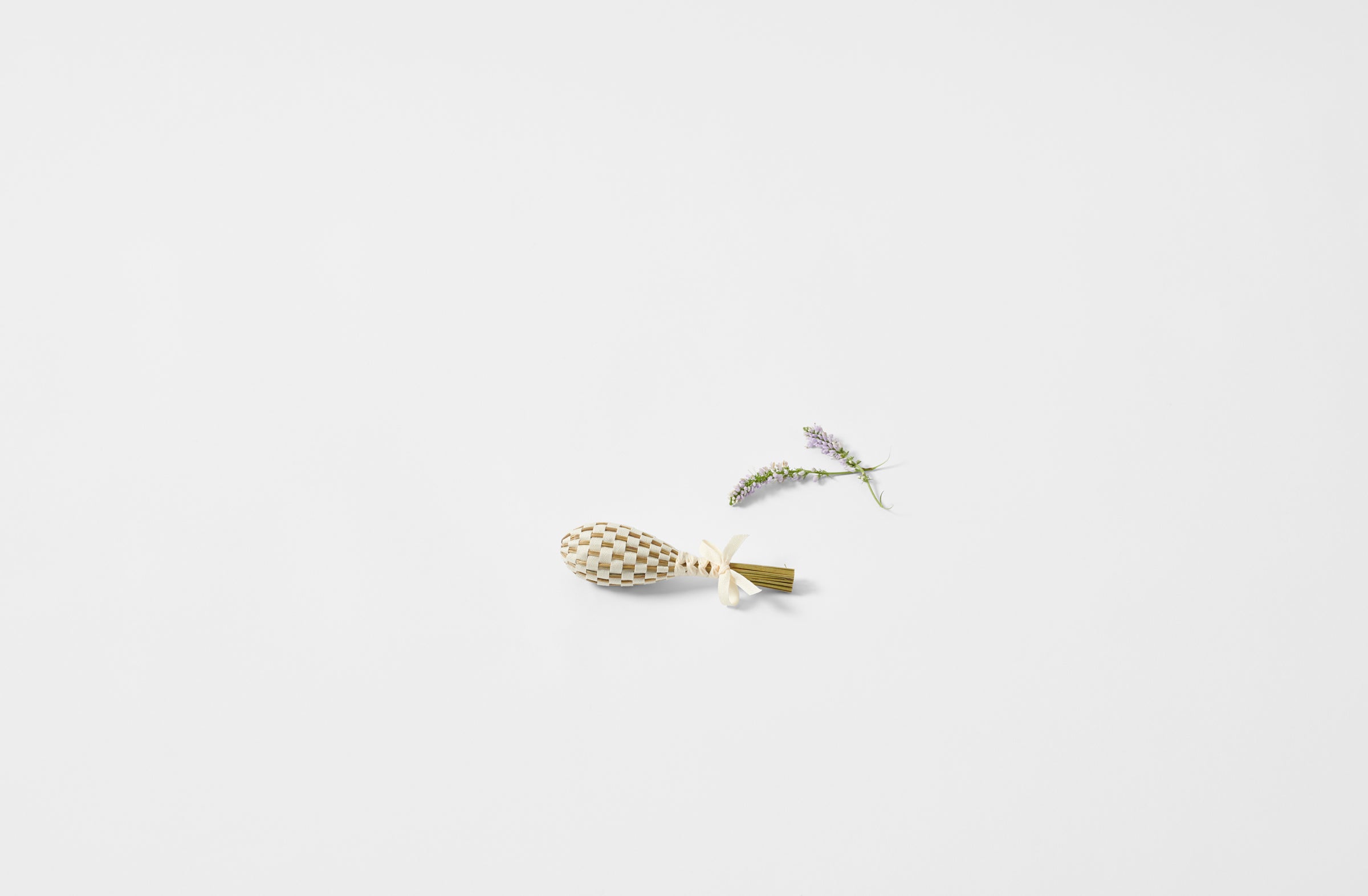 Petite lavender wand in linen next to sprig of lavender