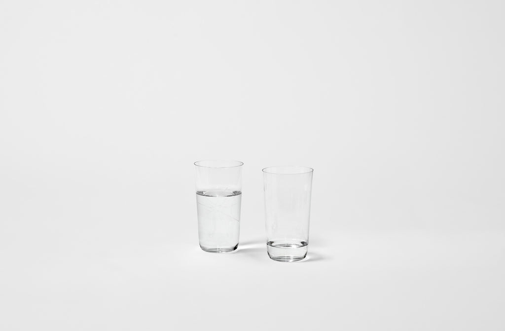 Two clear glass Lobmeyr tumblers filled with water on a white background. Default 