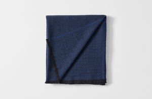 Maki blue throw blanket with detail of reverse.