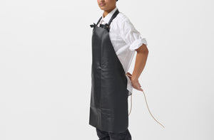 Model wearing Malle W. Trousseau black leather apron.