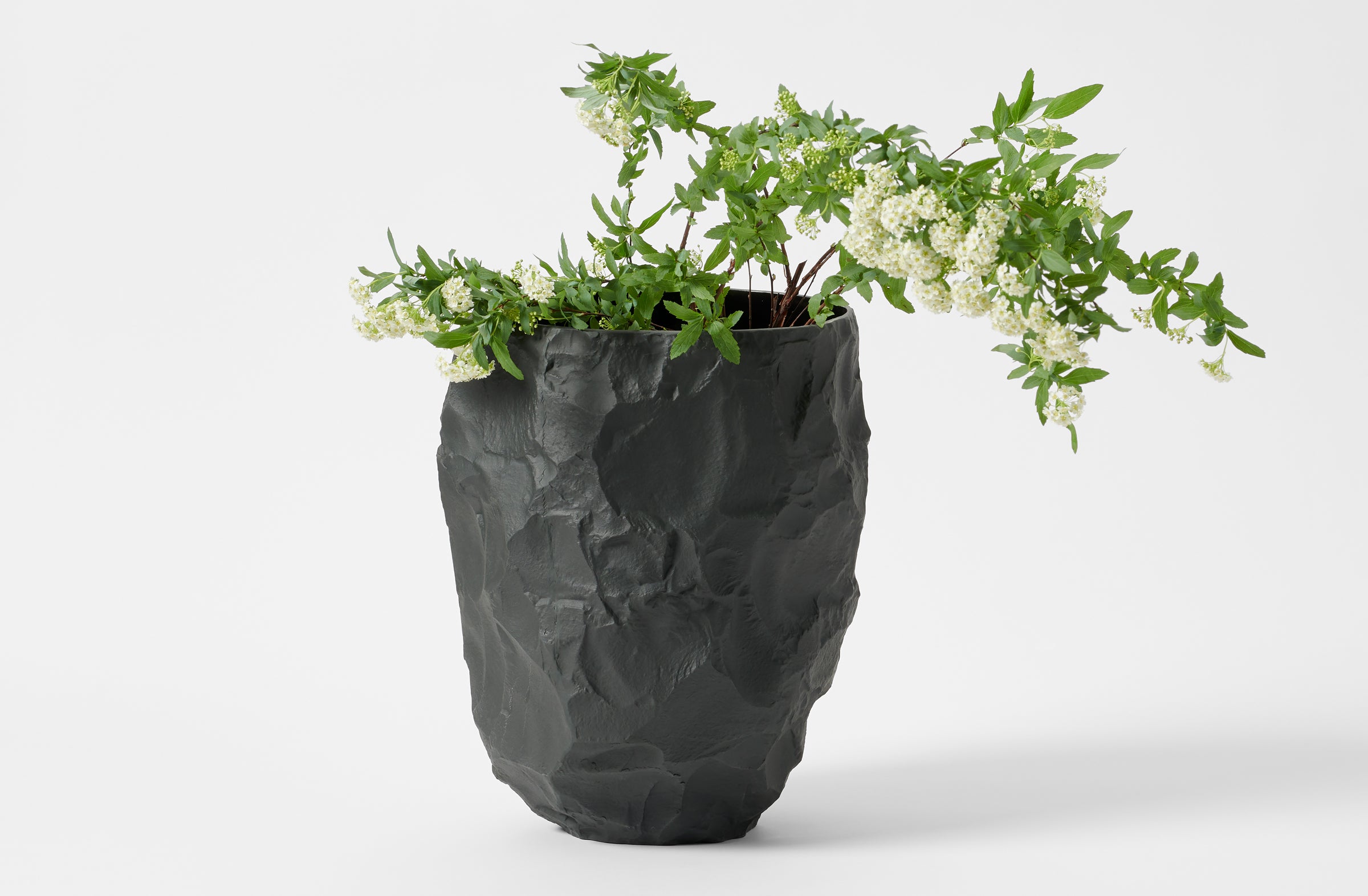 Max Lamb basalt crockery limited big vase holding flowering branches.