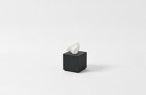 Michael Verheyden black leather tissue box with tissues.