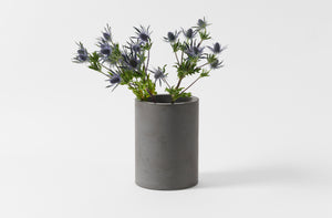 Michael verheyden dark grey concrete wide vase with arrangement of thistle