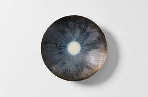 Small brass Michael Verheyden black and white resin bowl overhead.