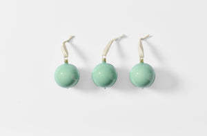 Set of three mint enamel ornaments.