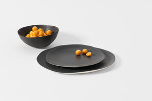 Molosco matte black dinnerware set with bright orange berries. Default