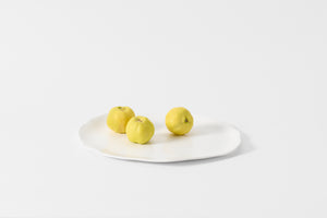 Molosco large white serving platter holding three quince fruits.