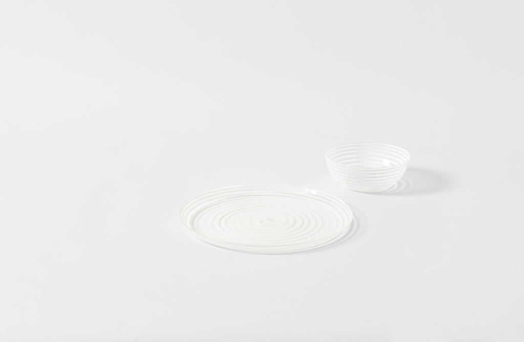 Murano striped white glass dinnerware on a light gray background. Default