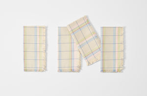 Four pastel napkins folded.