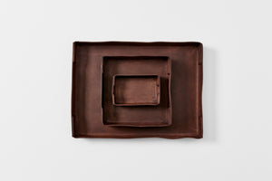 Peter Speliopoulos chestnut leather trays nested overhead. 