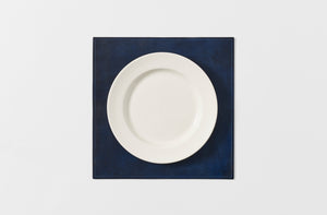 Peter Speliopoulos indigo painted leather placemat with plate