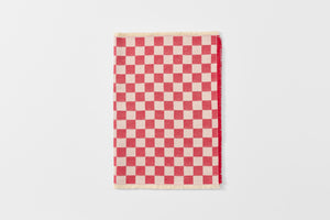 Red and cream checkered runner folded.