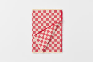 Red and cream checkered runner folded with detail of reverse.