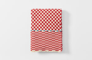 Red and cream checkered cashmere throw folded.