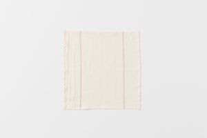 Open embroidered red stripe white linen napkin.