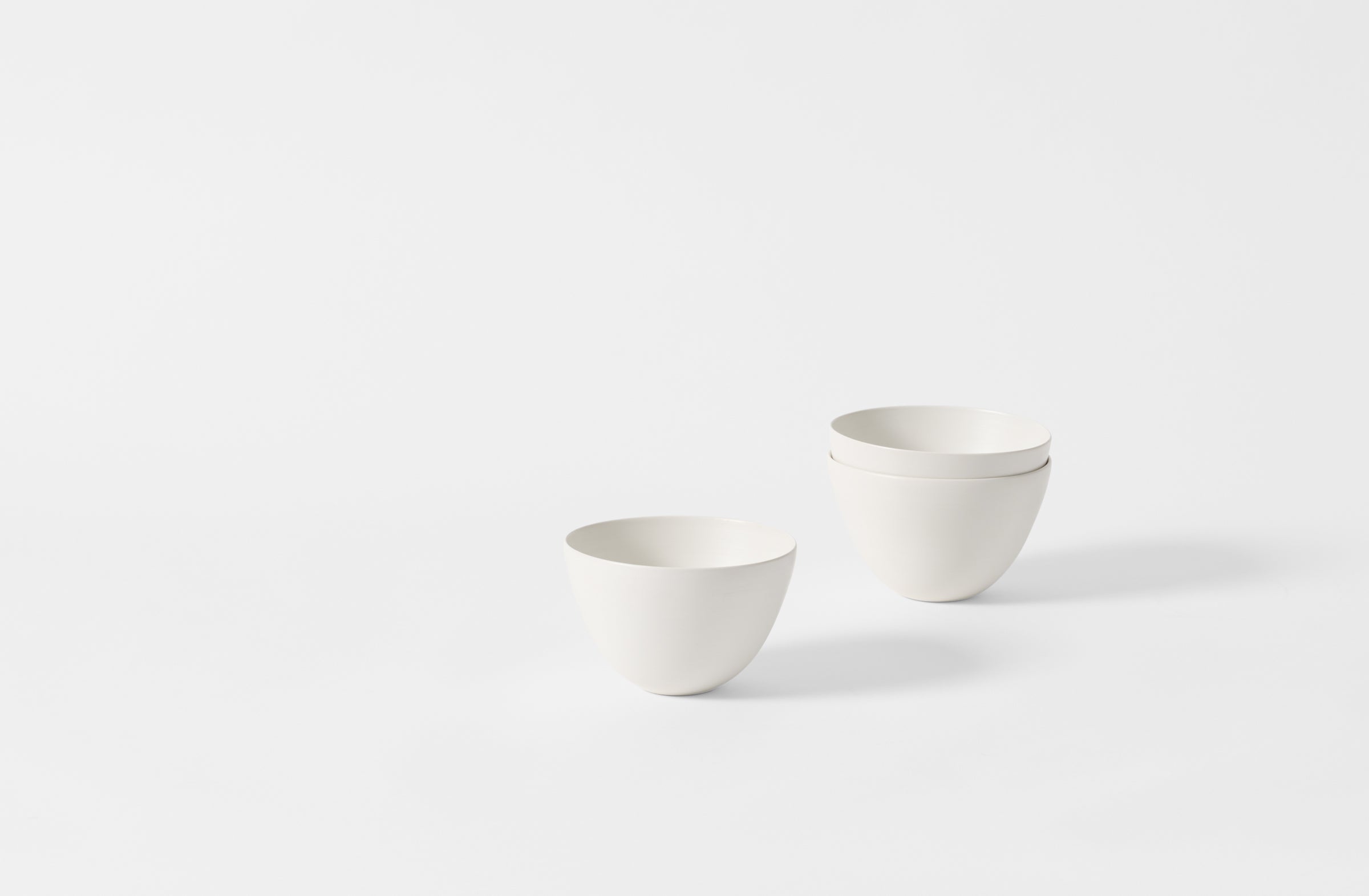 Three small deep white Rina Menardi bowls.