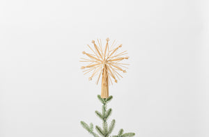 Straw snowflake tree topper on tree