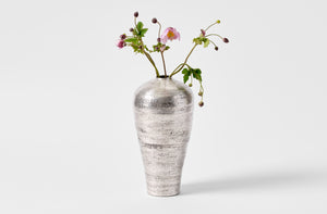 Takashi Endo large silver vase with arrangement of delicate pink poppy stems.