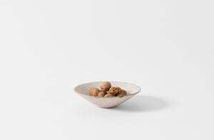 Takashi Endo white shallow bowl holding walnuts.