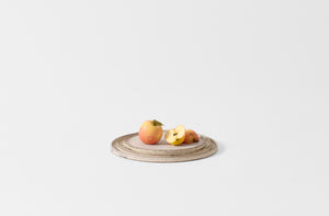 Takashi Endo stacked white plates. with apples.