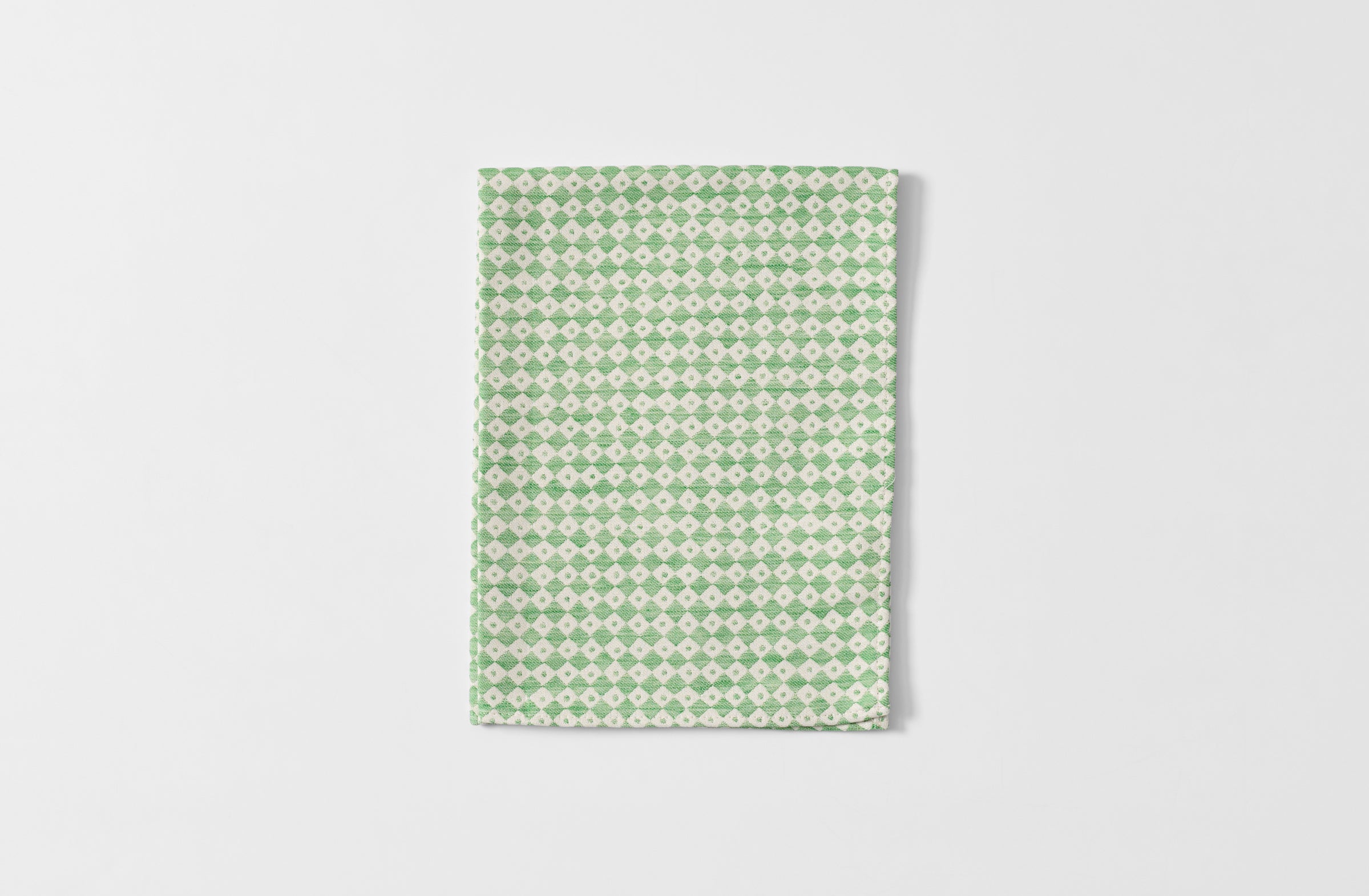 Folded Tori Murphy spruce check kitchen towel.