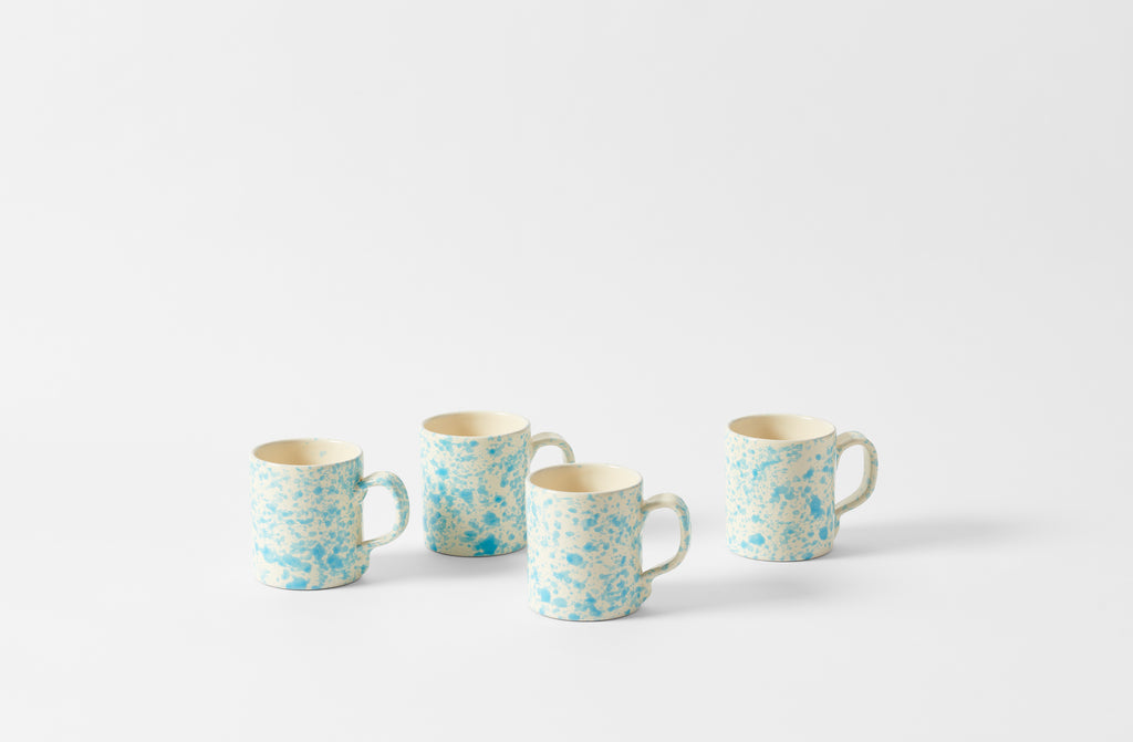 Four Turquoise and cream splatterware mugs.