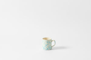 Turquoise and cream splatterware mug