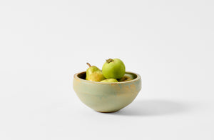 Victoria Morris copper ledge bowl with green pears and apples.