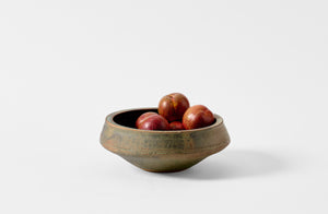 Victoria Morris lichen ledge bowl holding dark plums.