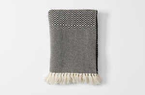 Vigo black and ecru woven blanket with fringe folded