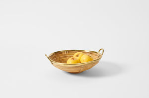 Vintage Gabrielle Christy shallow basket with brass rim holding apples.