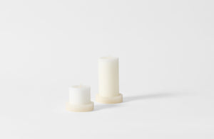 White onyx pillar candle holders with pillar candles.