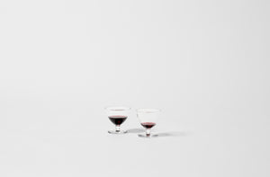 Two Yoshihiko Takahashi small glasses with red wine.