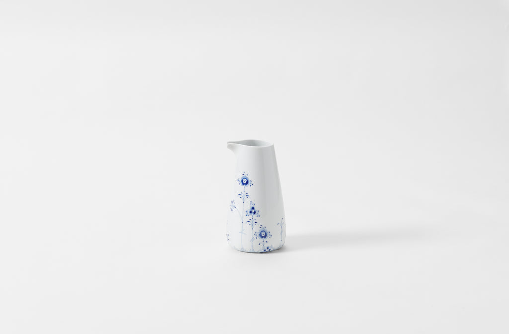 A white and blue floral patterned porcelain jug on a white background.